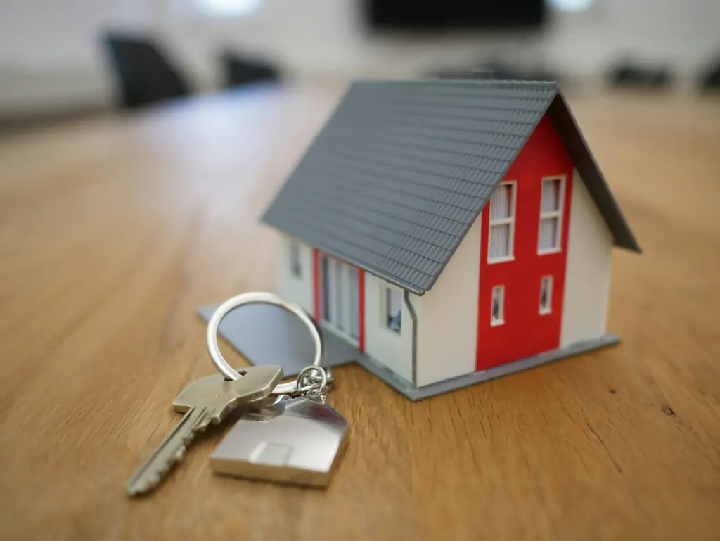 A set of house keys resting on a timber table