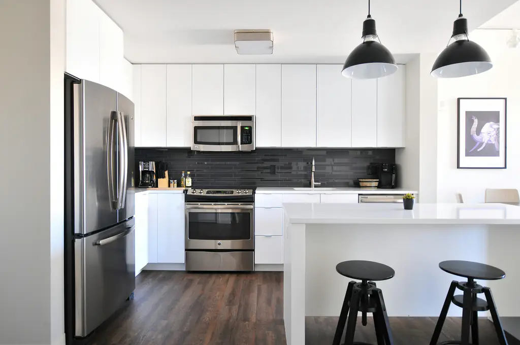 Black and white kitchen with a breakfast bar and pendant lighting