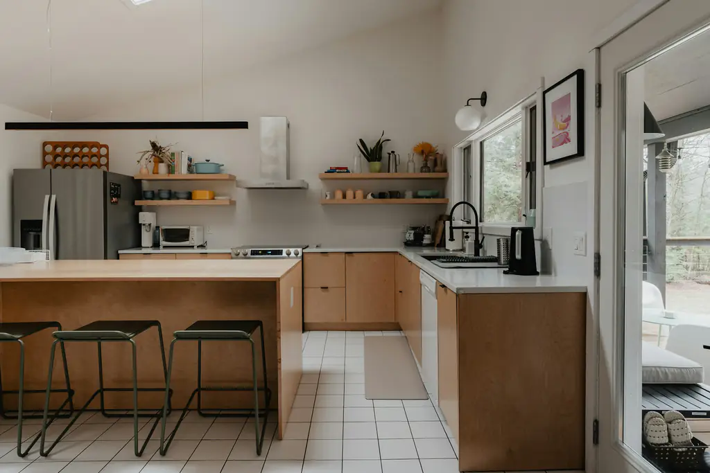 An open kitchen and dining space with stools around the counter